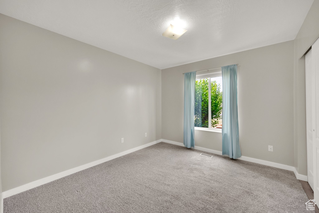 Empty room with baseboards and carpet floors