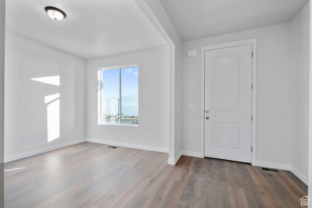 Foyer entrance featuring baseboards and wood finished floors