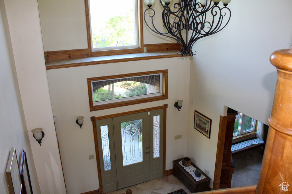 Foyer entrance with a chandelier and a high ceiling