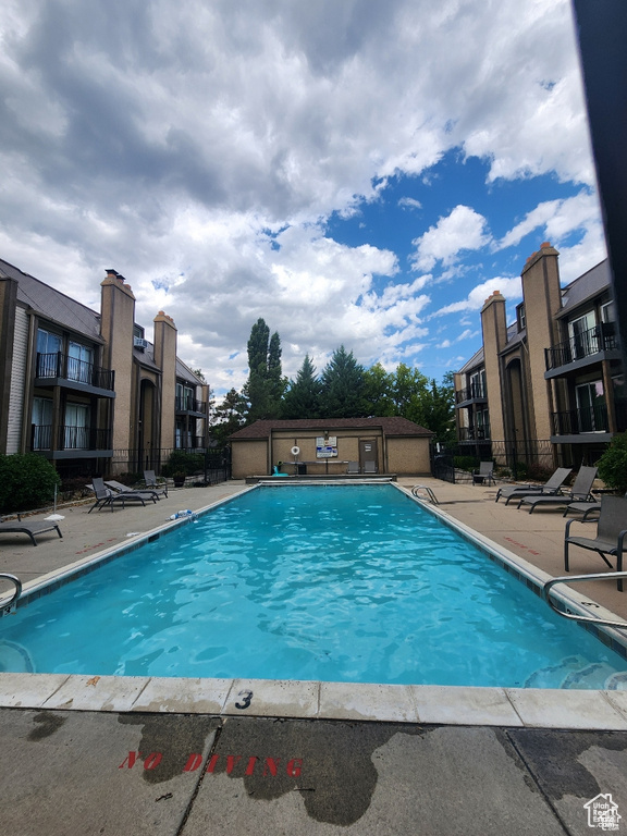 Community pool with a patio
