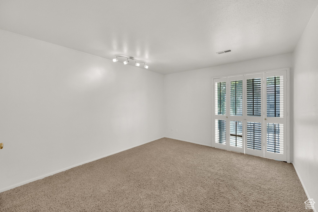 Spare room with carpet flooring and baseboards