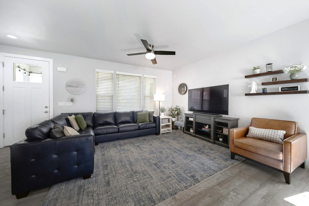 Living room with a ceiling fan and wood finished floors
