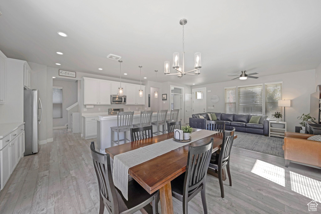 Dining space featuring a ceiling fan, a chandelier, light wood-style flooring, and recessed lighting