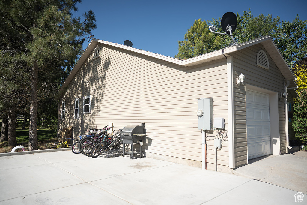 View of side of property with a garage
