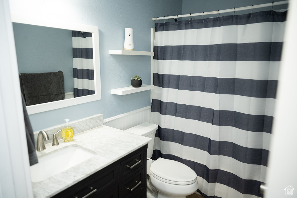 Bathroom with vanity and curtained shower
