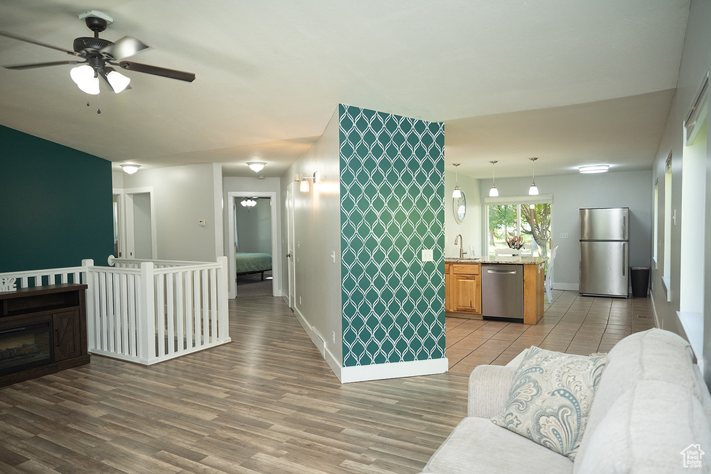 Living area featuring ceiling fan and light wood finished floors