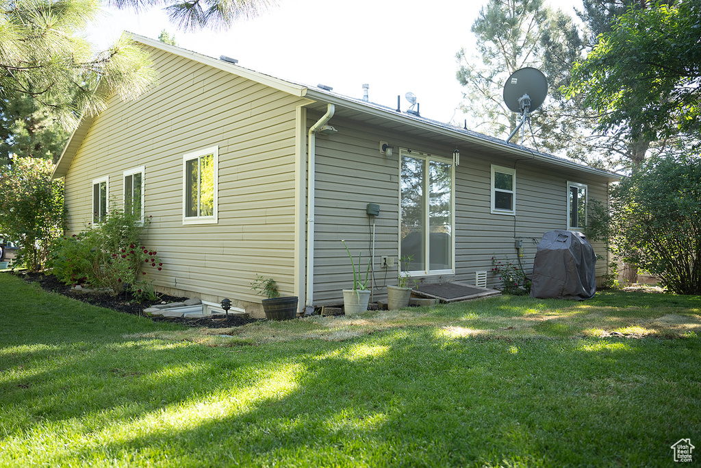 Back of house featuring a lawn
