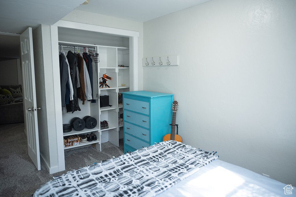 Carpeted bedroom with a closet
