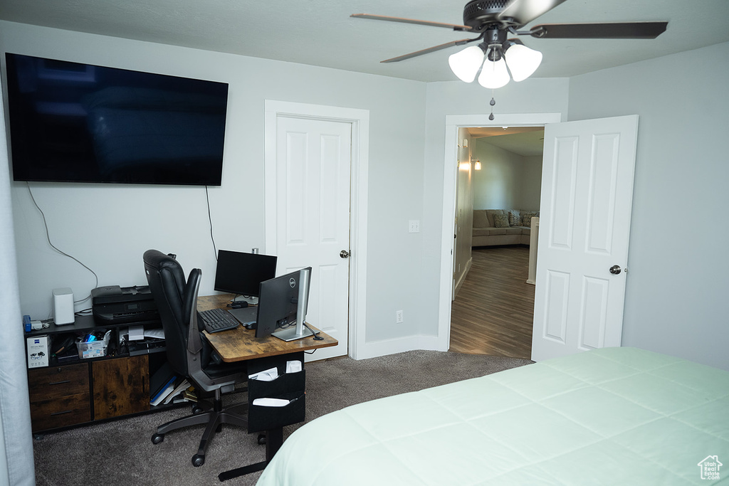 Bedroom featuring carpet, a desk, and a ceiling fan