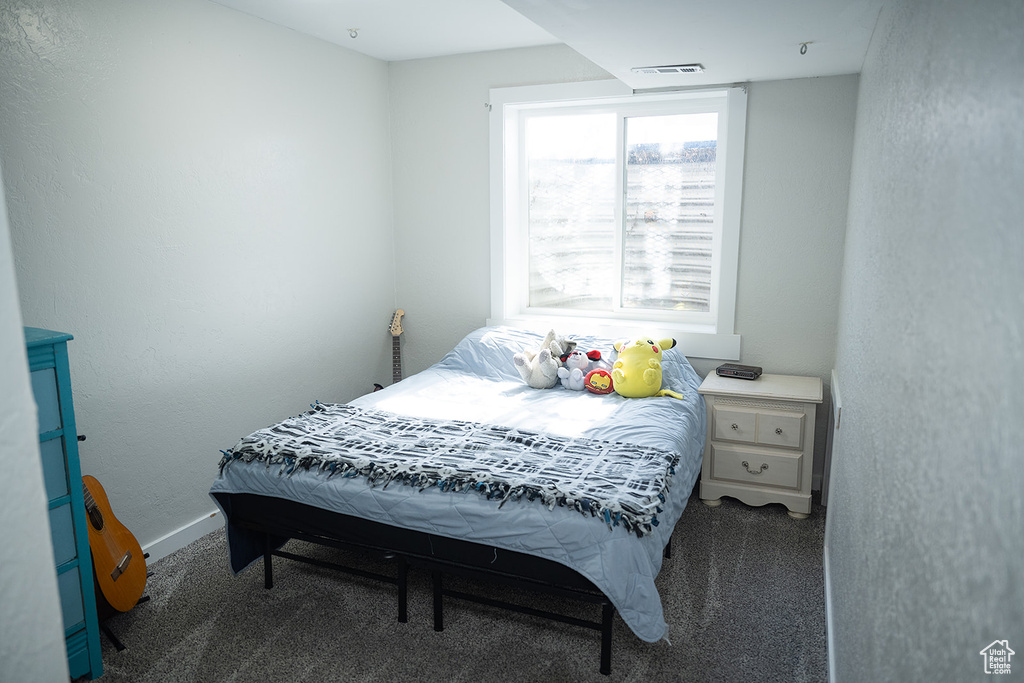 Carpeted bedroom featuring baseboards