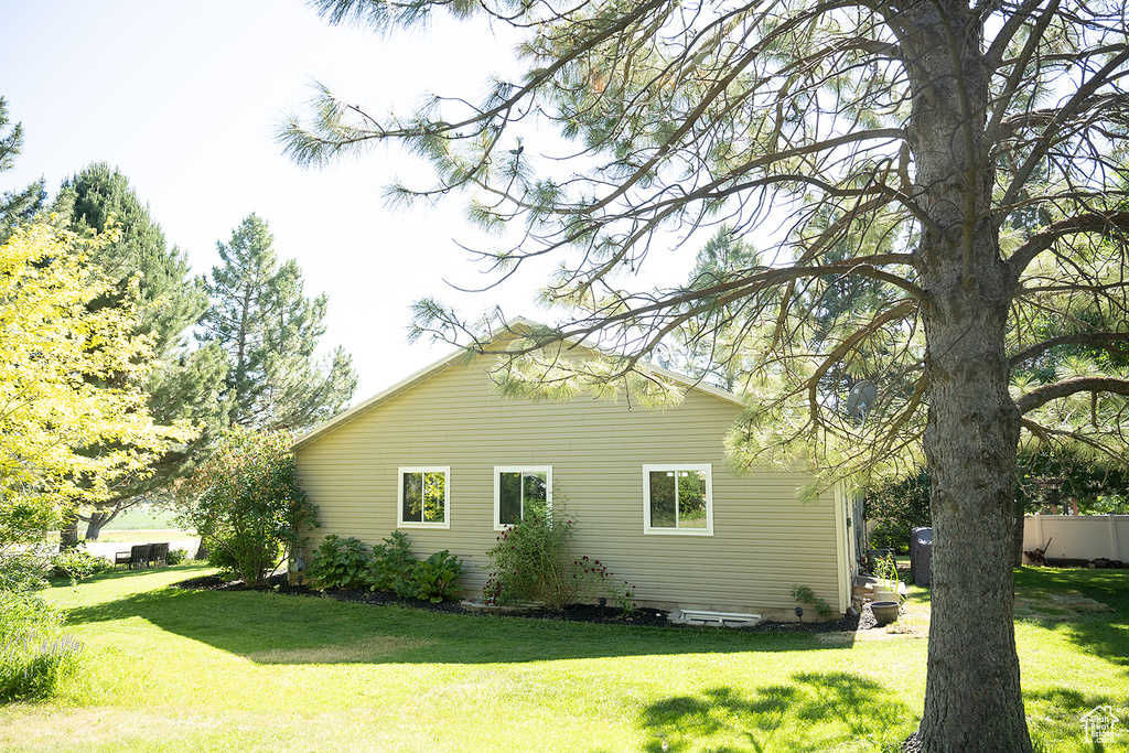 View of property exterior featuring a yard