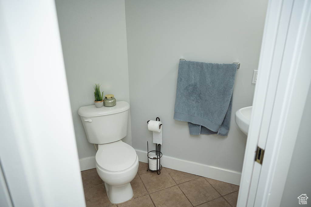 Bathroom with toilet and tile patterned flooring