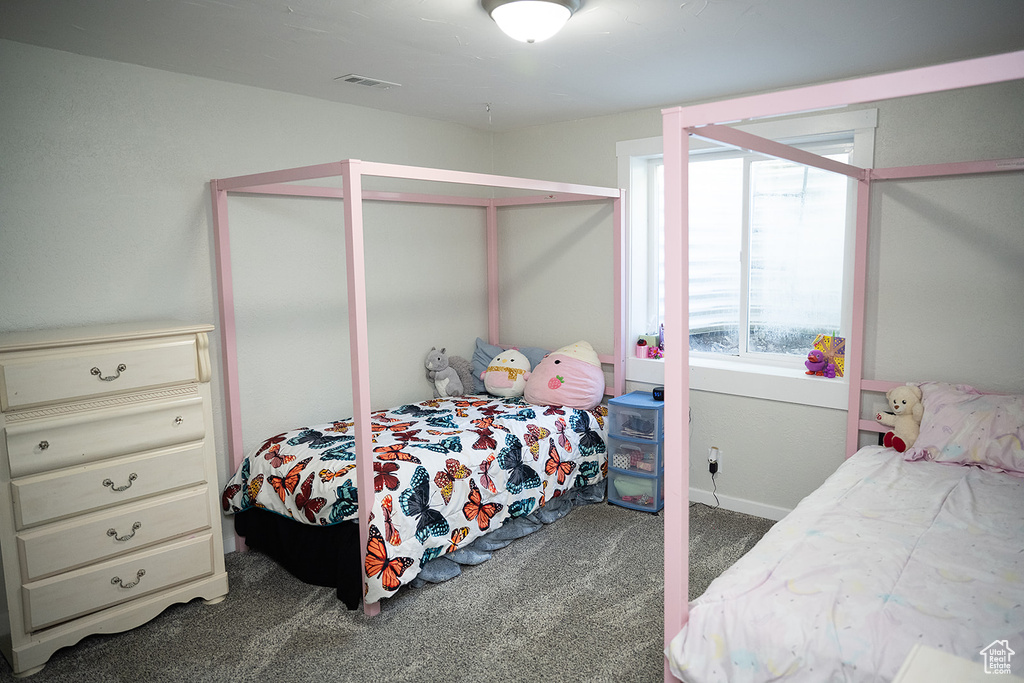 Carpeted bedroom with baseboards