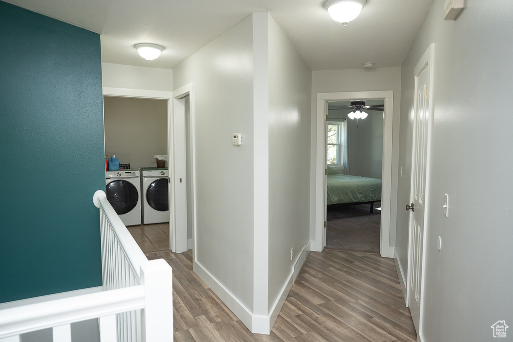 Hallway with washer and clothes dryer and light wood-style flooring