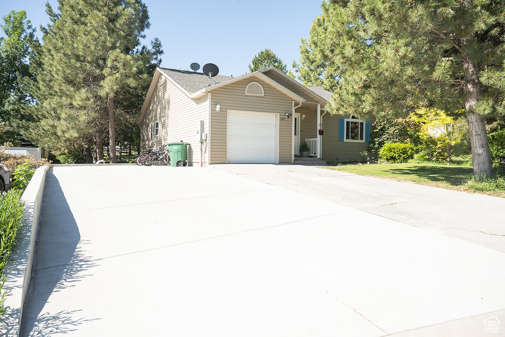 View of front of property with a garage and concrete driveway