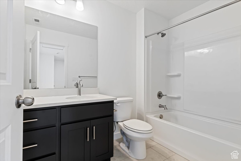 Full bathroom with tile patterned floors, vanity, toilet, and shower / bath combination