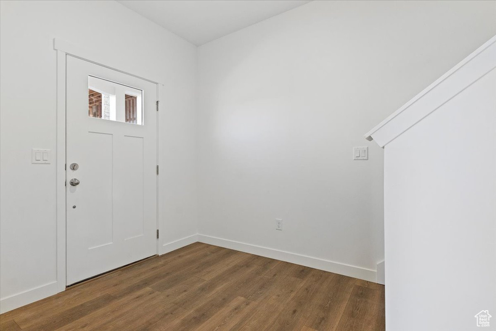 Foyer with wood finished floors and baseboards