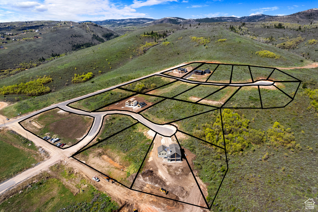 Aerial overview of property's location featuring property boundaries highlighted and a mountainous background