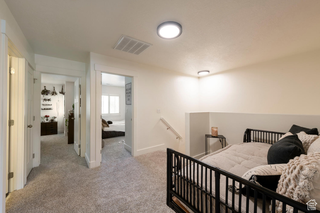 Bedroom with light carpet and baseboards