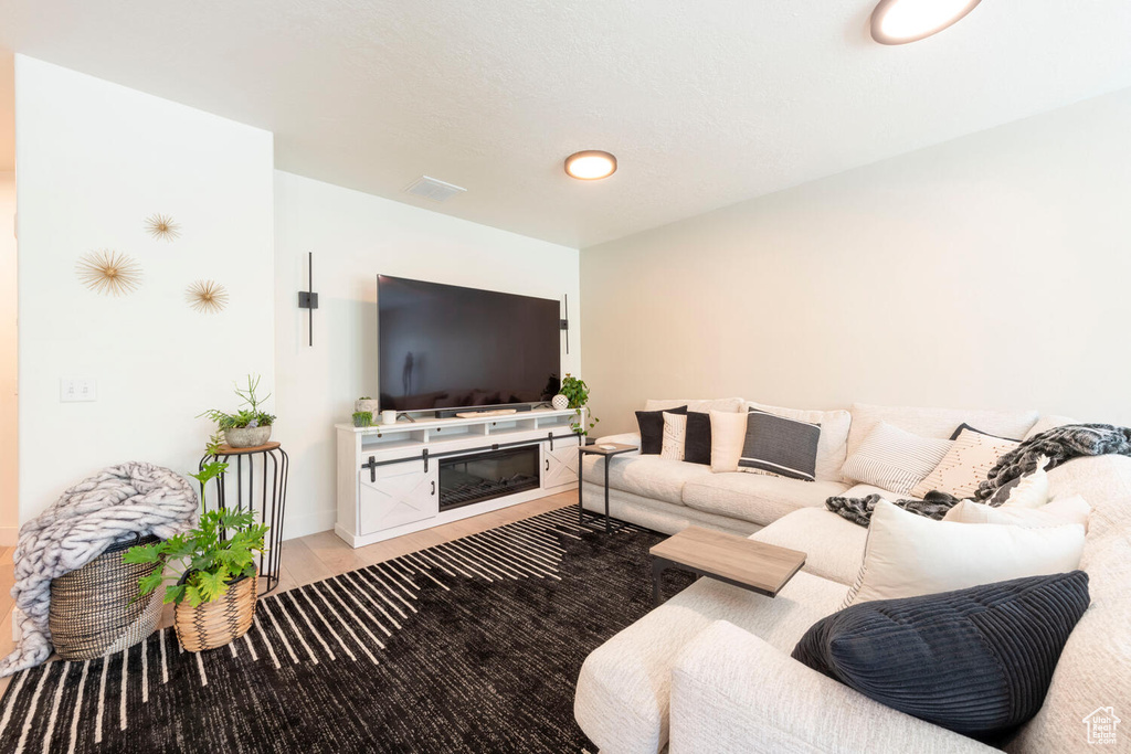 Living area with wood finished floors and baseboards