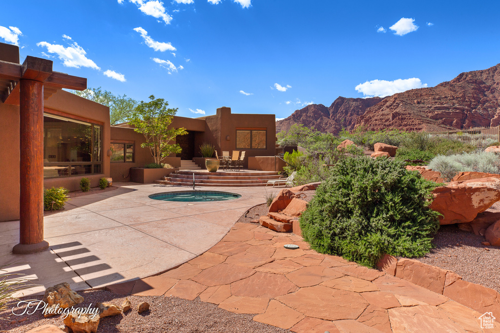 View of pool featuring a mountain view and a patio