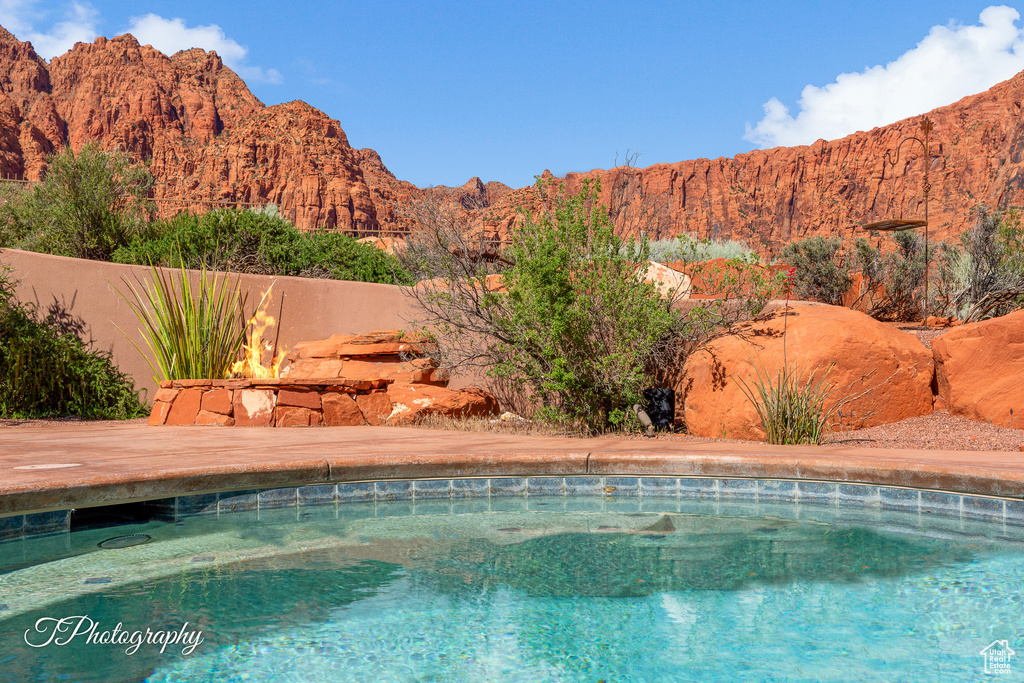 View of swimming pool with a mountain view