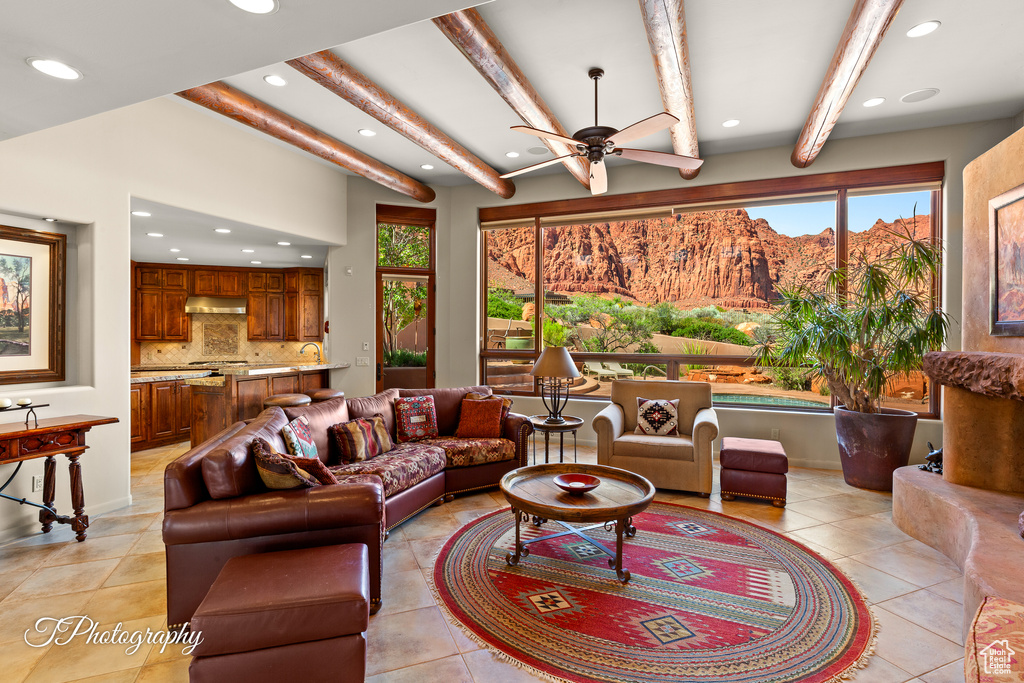 Living area with healthy amount of natural light, recessed lighting, light tile patterned flooring, beam ceiling, and a ceiling fan