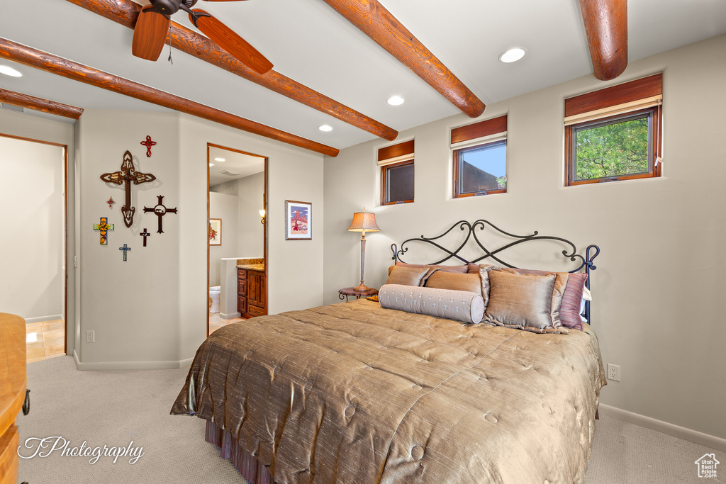 Bedroom featuring light colored carpet, beamed ceiling, recessed lighting, baseboards, and ensuite bathroom