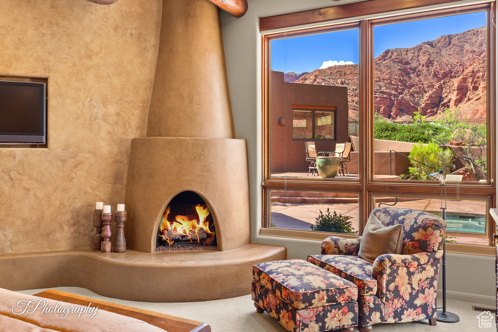 Living area featuring a mountain view and carpet