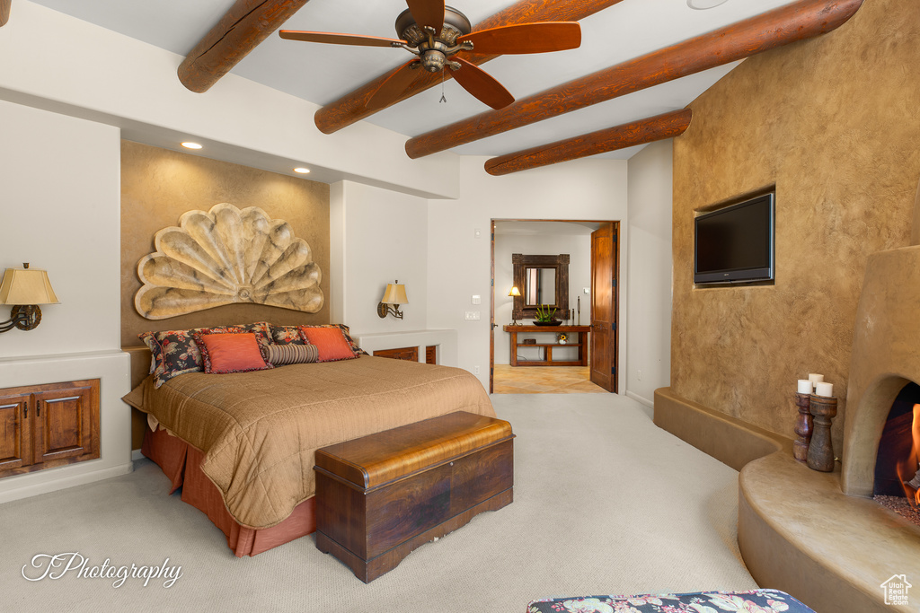 Bedroom with beamed ceiling, light colored carpet, and recessed lighting