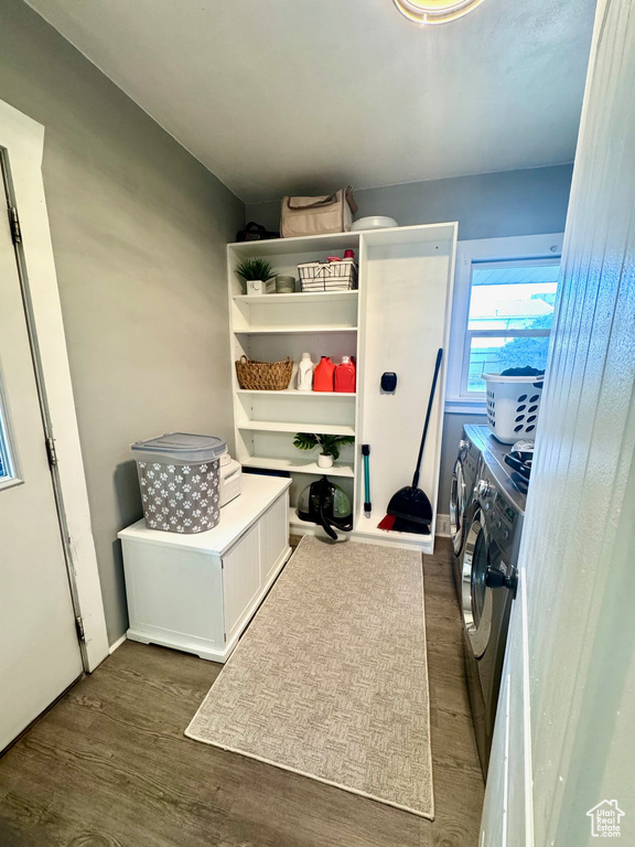 Washroom with separate washer and dryer and dark wood-type flooring