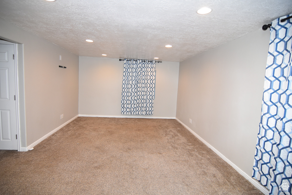 Unfurnished room with carpet, a textured ceiling, recessed lighting, and baseboards
