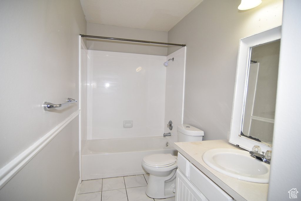 Full bath featuring toilet, vanity, and shower / washtub combination