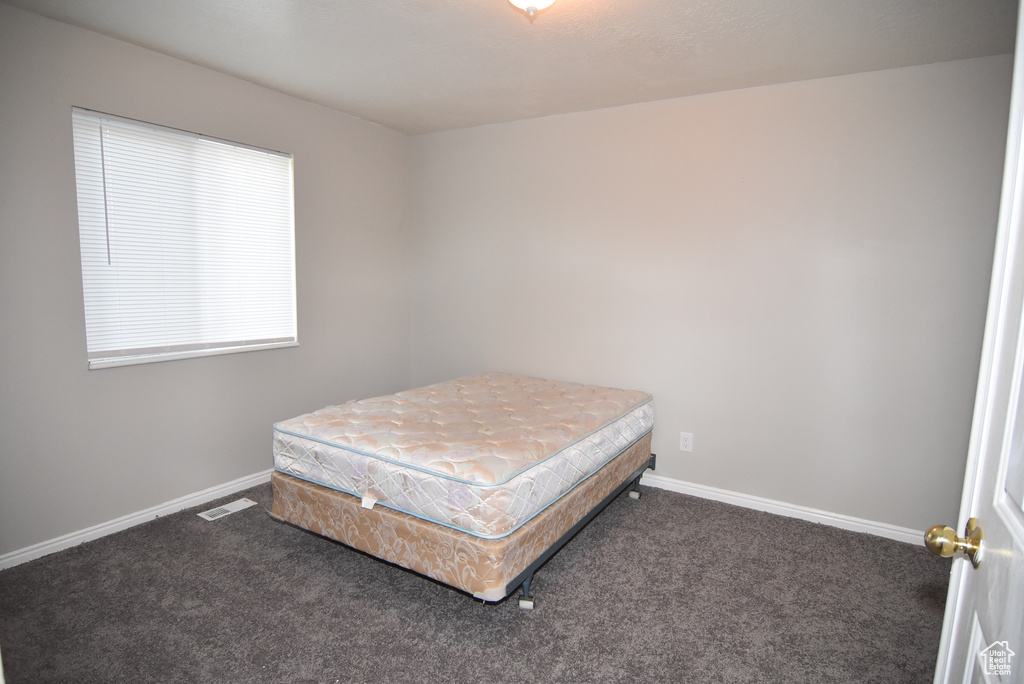 Carpeted bedroom with baseboards