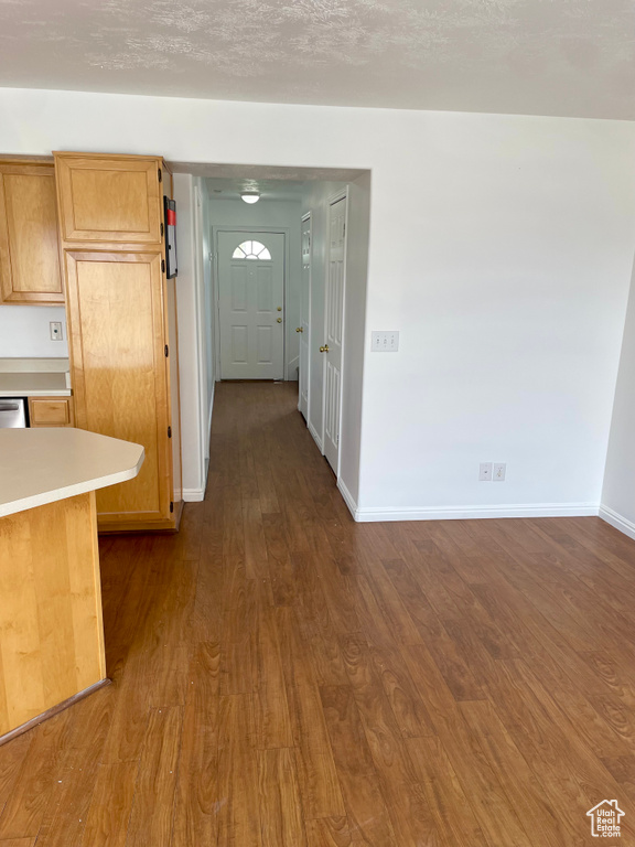 Corridor with baseboards and dark wood-style flooring