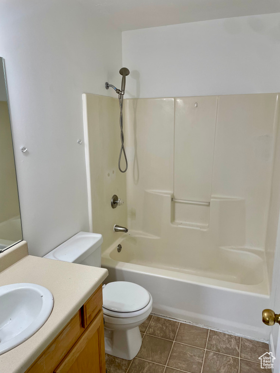 Bathroom featuring vanity, shower / washtub combination, and toilet