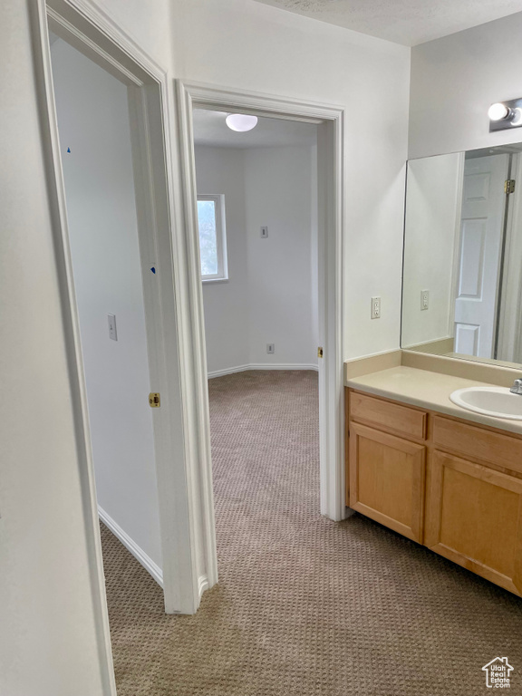 Bathroom featuring vanity and baseboards