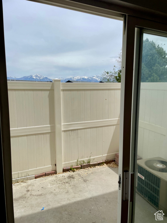 Fenced backyard featuring a patio, a mountain view, and central AC