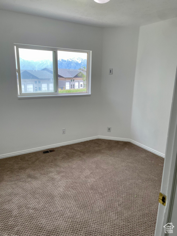 Spare room with carpet flooring and baseboards