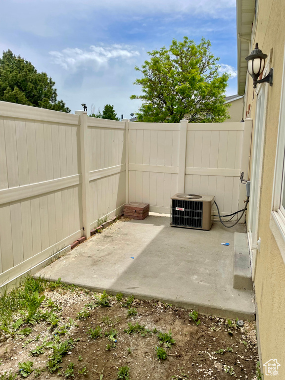 Fenced backyard with central AC and a patio