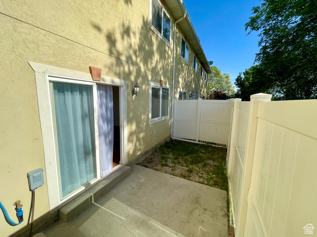 View of side of property with a patio area and stucco siding