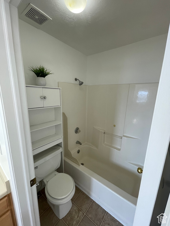 Bathroom with bathtub / shower combination and tile patterned floors