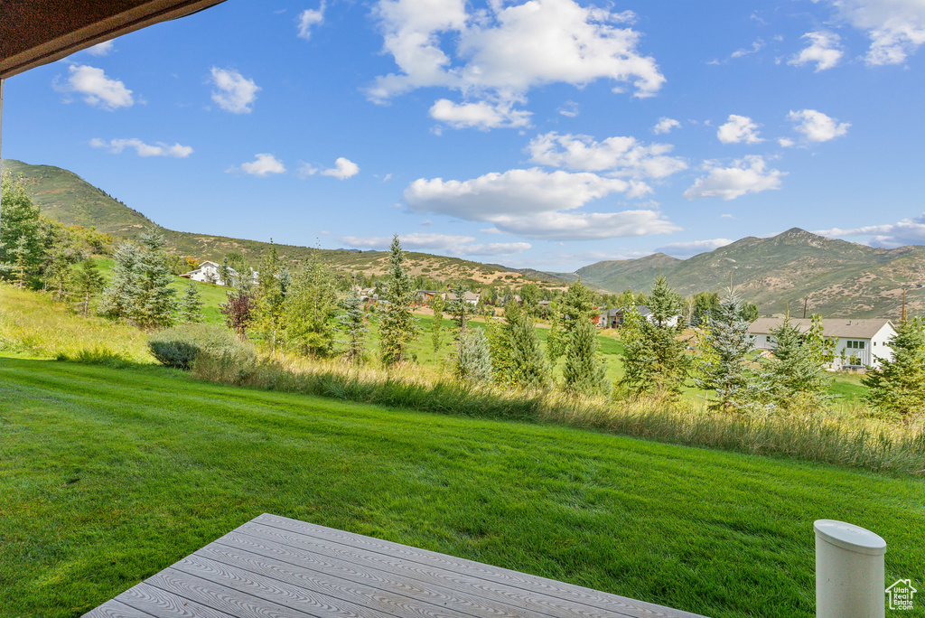 View of grassy yard with a mountain view