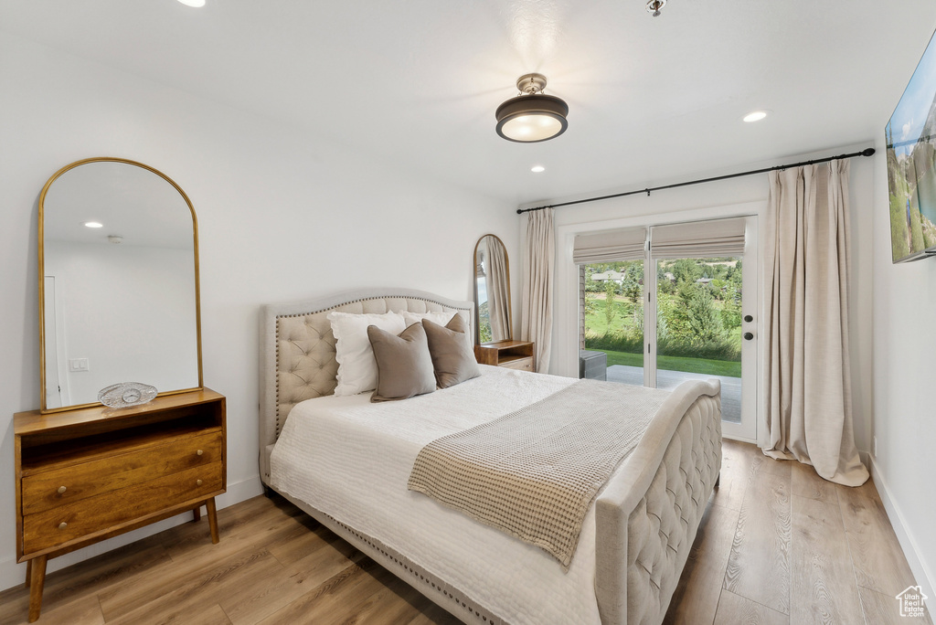 Bedroom featuring access to outside, light wood-style flooring, baseboards, and recessed lighting
