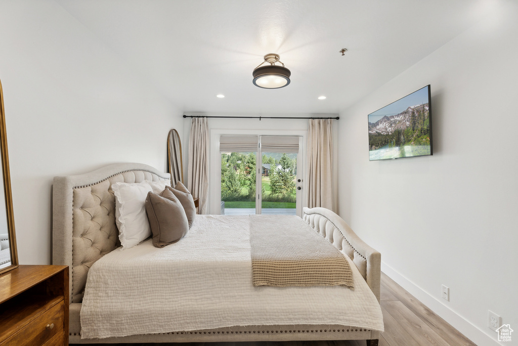 Bedroom with access to outside, light wood-style flooring, baseboards, and recessed lighting
