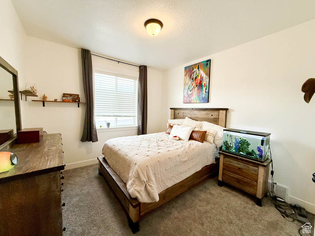 Carpeted bedroom featuring baseboards