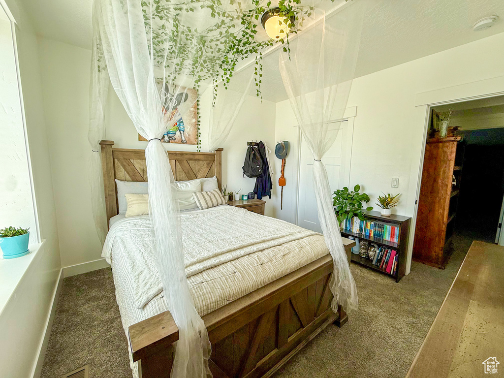 Bedroom with carpet flooring and baseboards