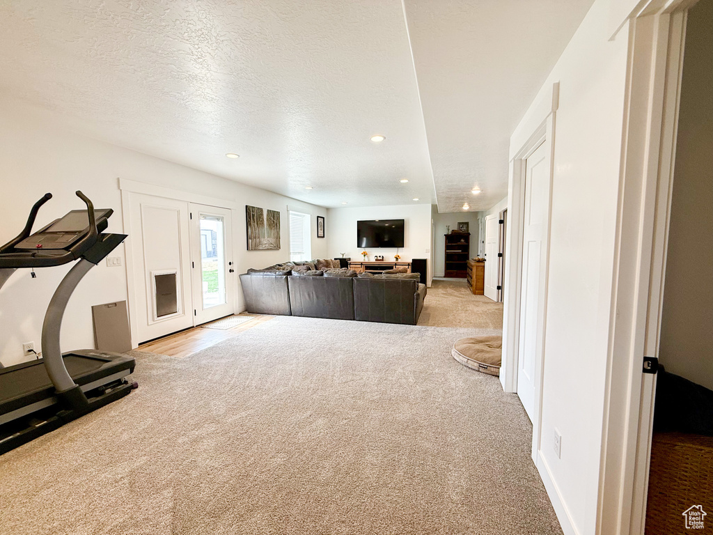 Workout room with carpet floors, recessed lighting, and a textured ceiling