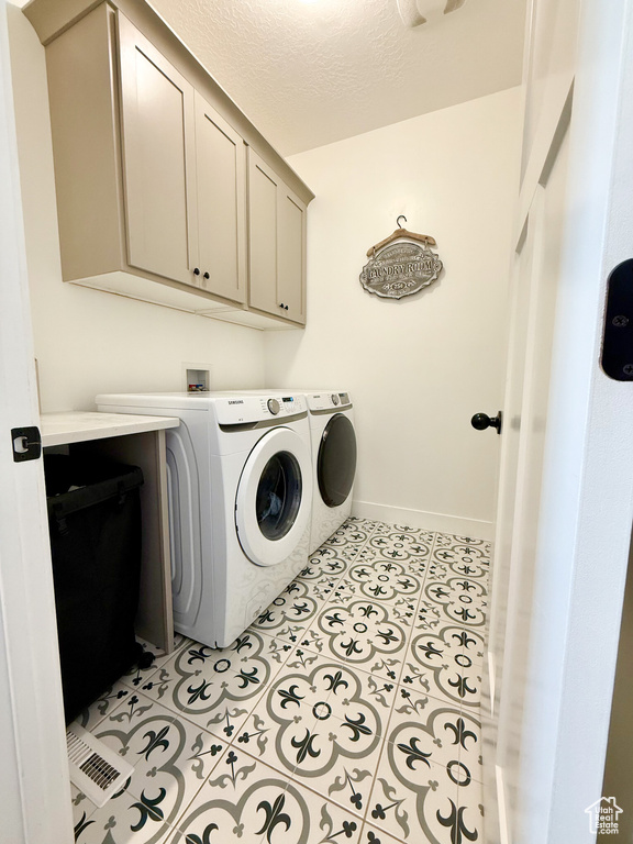 Laundry room with cabinet space, washing machine and clothes dryer, and baseboards