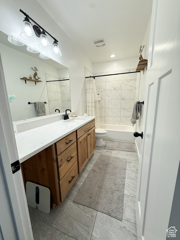 Full bath with vanity, shower / bath combination with curtain, and toilet